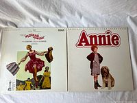 Front covers of both soundtrack LPs side by side