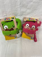 Front view of both packaged plush keychains