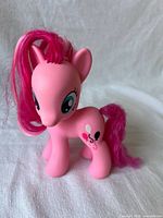 Front left view of Pinkie Pie figure showing body, mane, eyes, and cutie mark