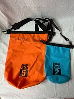 Both dry bags front view showing colors, sizes, and printed capacities