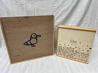 Both wooden boxes front view, showing bird graphic box and SOMA floral box