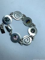 Full view of sterling bracelet showing disc links and clasp