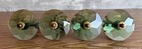 Front view of all four green faceted glass knobs aligned