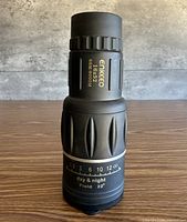 Full view of Enkeeo 16x52 monocular showing brand, magnification, objective size and field data