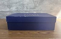 Side view of dark blue Stuart Weitzman shoe box