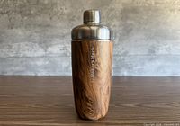 Full view of shaker front showing wood-grain exterior and lid