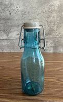 Front view of blue glass bottle with stopper