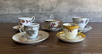 Group shot showing five teacup and saucer sets