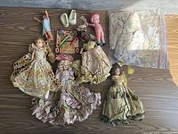 All items laid out: seven dolls, Little Lasso game, doll shoes, accessories