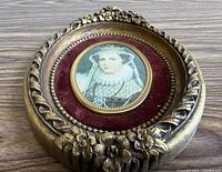Front view showing miniature portrait, red velvet mat, gilt frame details