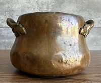 front view showing hammered copper body and handles