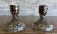 Pair of iridescent marigold glass candlestick holders, front view