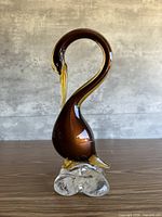 Front left profile of Murano glass swan on clear base