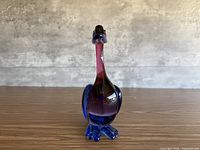 Front view of blue and cranberry Sommerso glass duck figurine