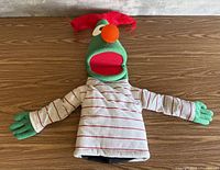 Full view of HandiSphere puppet laid flat showing size, colors, shirt