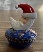 Front view of porcelain Santa moon trinket box showing lid design and clasp