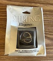 Front of retail package showing Sterling Elegance branding and leverback earrings inside