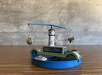 Front view showing carousel with lighthouse tower, arm, zeppelin and airplane