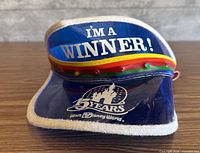 Front view showing "I'm a Winner!" text, rainbow band, castle logo, overall design