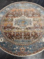 Full view of the round rug showing entire pattern and color palette