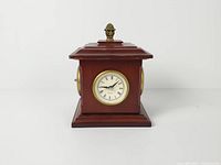 Front view showing quartz clock dial and finial