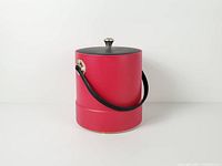Full view of red cylindrical ice bucket showing handle and lid
