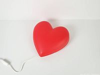 Front view of red heart wall lamp with cord visible