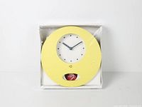 Front view of clock in original box showing overall design