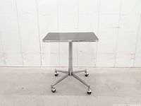 front view of table showing pedestal and casters