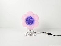 Front view of pink popcorn plastic flower lamp showing purple center and spiral base