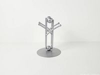 Front view showing intersecting rods, spheres and circular base