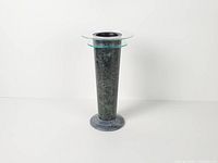 Full frontal view of tall green marble vase with lucite discs and marble base