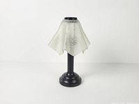 Front view of assembled tealight lamp showing frosted shade and metal base