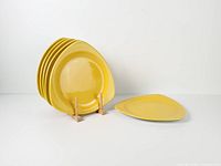 All six yellow triangular plates with one plate displayed on stand