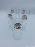 Front view of five SKOL beer glasses