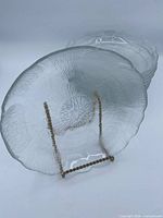 Front view of two bowls showing textured design and scalloped rim