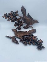 Front view of resin wall plaque showing birds and floral design