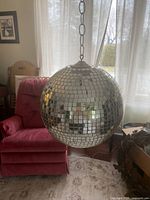 Full view of disco ball suspended from chain