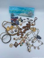 Overall view showing majority of jewelry pieces and bag of damaged parts