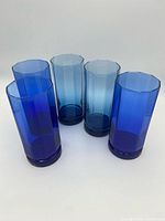 Five faceted glass tumblers, three cobalt, two aqua