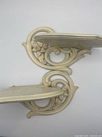 Top view of both cream floral wall shelves