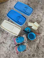 Group shot of all canisters, camping kit boxes, tumblers, bowls and utensils