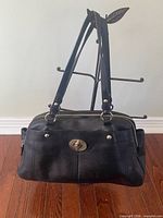 Full view of handbag showing shape, straps, and overall condition