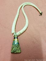 Full view of the heishi bead necklace with triangular stone pendant