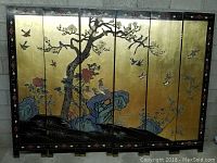 Full view of 6-panel Asian privacy screen with gold background, birds, tree, flowers and rocks painted on one side.