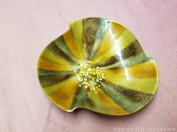 Top view showing colorful swirl pattern and stones embedded in center of the dish.