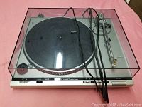Full view of the Technics SL-D30 turntable with dust cover, power cord visible on top.