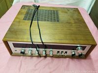 Front and top view of Panasonic SA-790 stereo receiver showing wood finish, control panel with knobs, and power cord