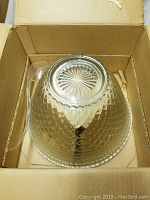 Glass punch bowl with detailed cut pattern viewed from above, showing shape and ladle handle.