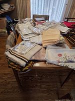 assortment of folded table linens spread on dining table